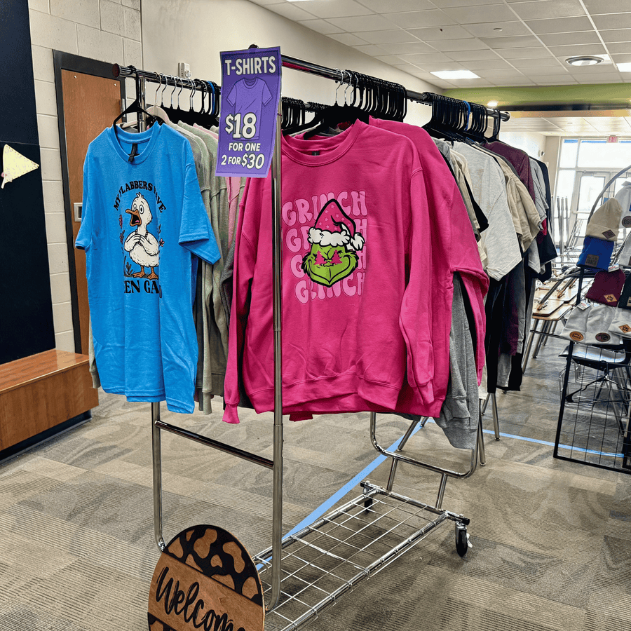 Colorful t shirts and sweat shirts on a retail rack with designs