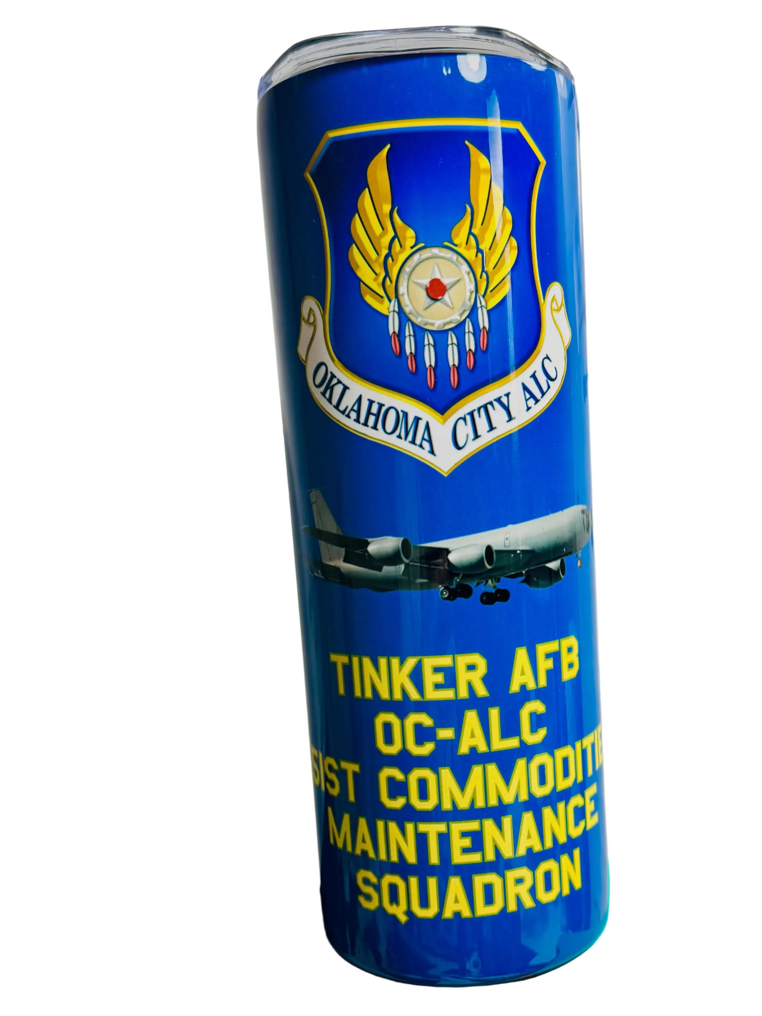 Blue tumbler with military insignia and text on a green box against a whiteboard background